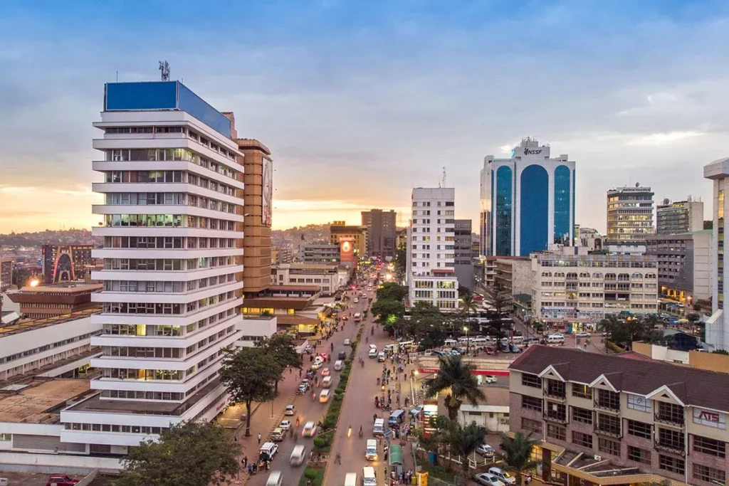Kampala city skyline at sunset with high-rise buildings and busy urban street showing Uganda’s growing real estate market