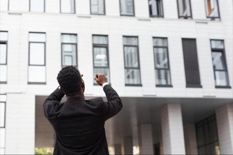 Man standing infront of an apartment newly bought