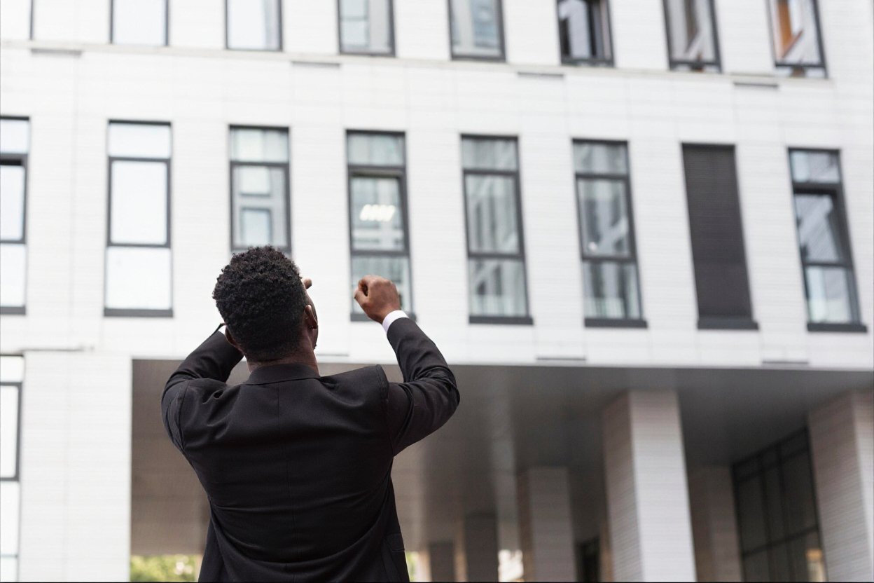 Man standing infront of an apartment newly bought